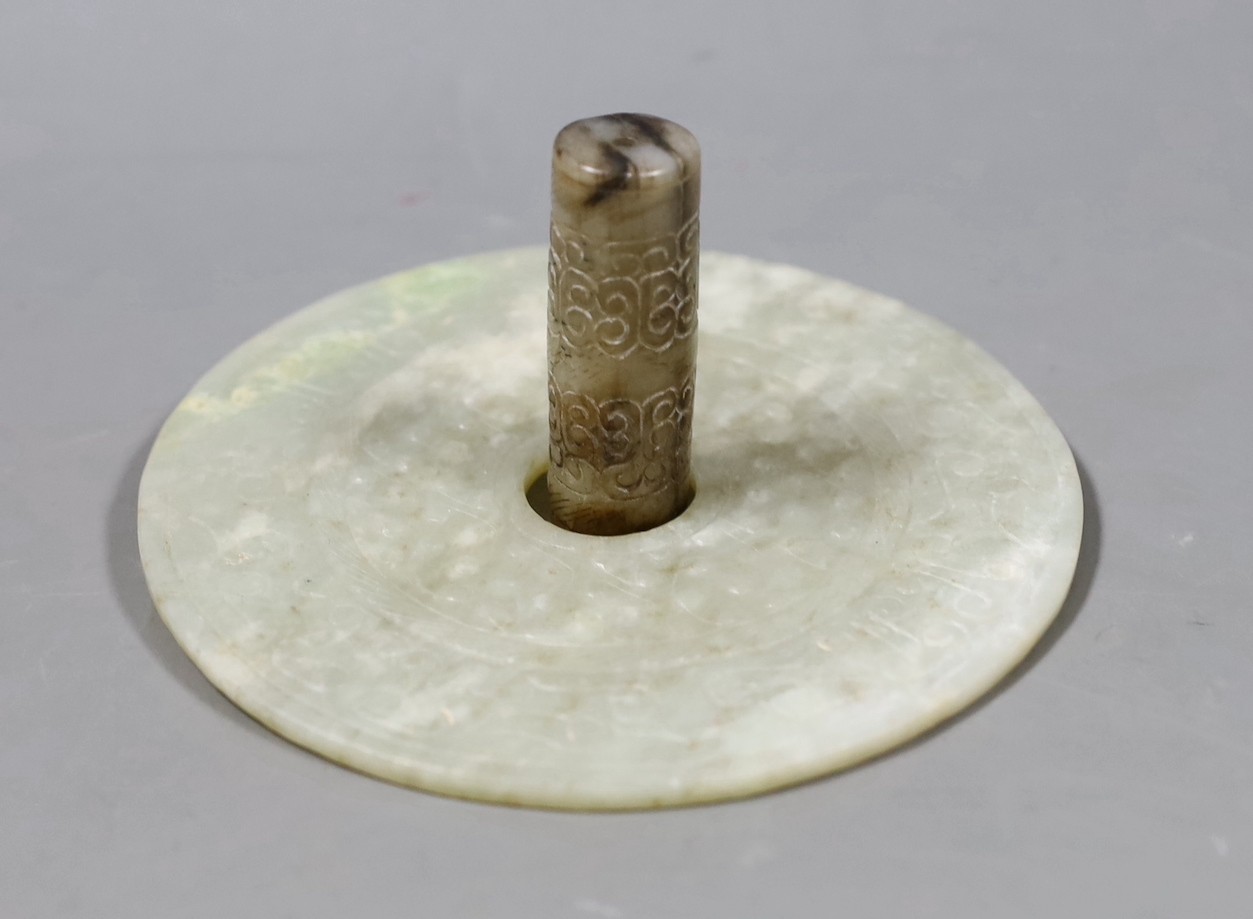 A Chinese archaistic white and black jade cylinder bead, 5.8 cm, boxed and a Chinese archaistic jade large bi disc, 13 cm diameter